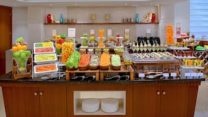A buffet with various food options and a sign indicating 'Just Desserts'.