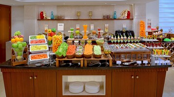 A buffet with various food options and a sign indicating 'Just Desserts'.