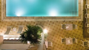 A large indoor swimming pool with clear water, surrounded by a tiled wall and a staircase leading down. - Eliza Hotel by Panel Hospitality (Dio-Olympos)