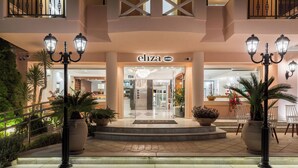 A hotel entrance with a central staircase, potted plants, and a sign reading "eliza". - Eliza Hotel by Panel Hospitality (Dio-Olympos)