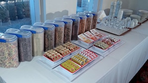 A buffet table with various food items and containers. - Millicent Motel (Millicent)