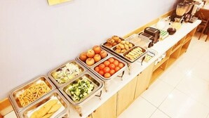 A buffet with various food items including fruits, vegetables, and prepared dishes. - Paju Golden Hill (Paju)