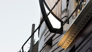 A hotel sign with the name 'HOTEL WW atamis' in a modern, geometric design.