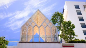 A modern building with a unique geometric facade and a clear blue sky in the background. - UCSI Hotel Kuching (Kuching)