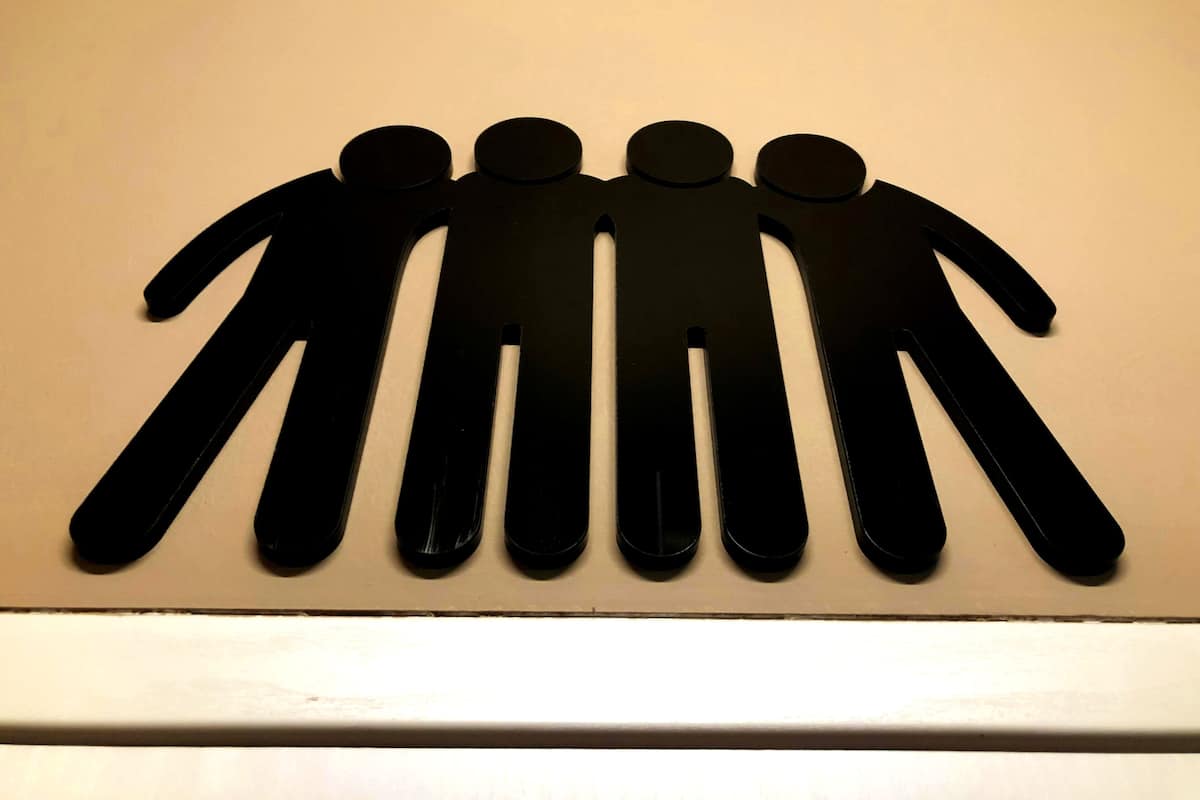 A wall-mounted silhouette of five figures.