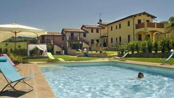 Outdoor pool, pool umbrellas, sun loungers