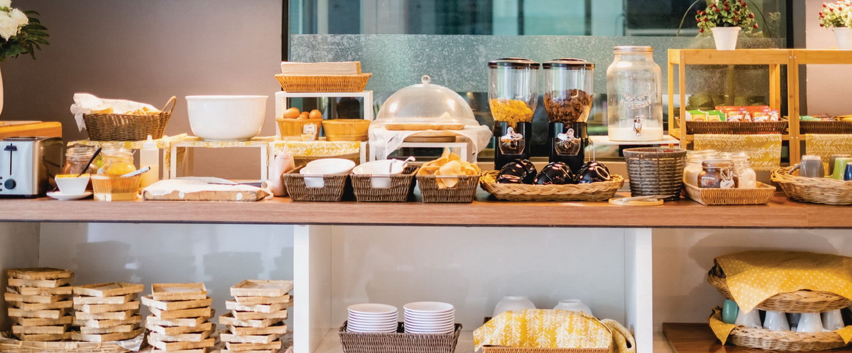 A buffet setup with various food items, baskets, and serving dishes.