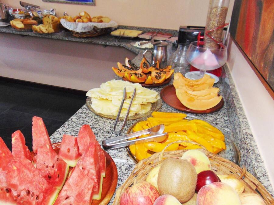 A buffet with various fruits and pastries.