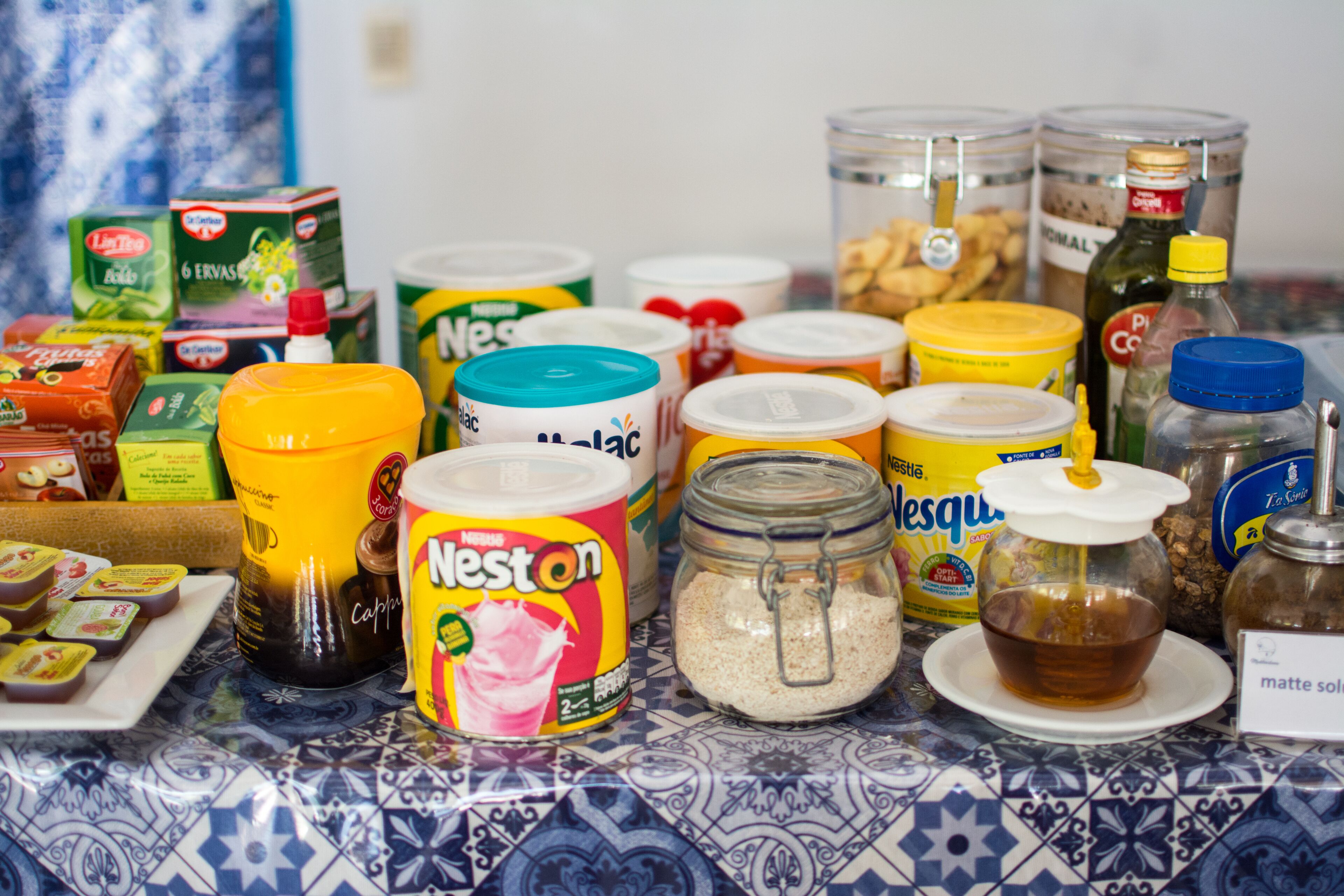 A table with various food items including Neston ice cream, jars of spices, and condiments.