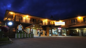 A hotel named Companion with a reception desk, a staircase, and a parking area. - Companion Hotel Motel (Hearst)