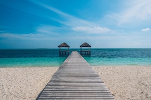 On the beach, white sand, beach umbrellas, beach towels