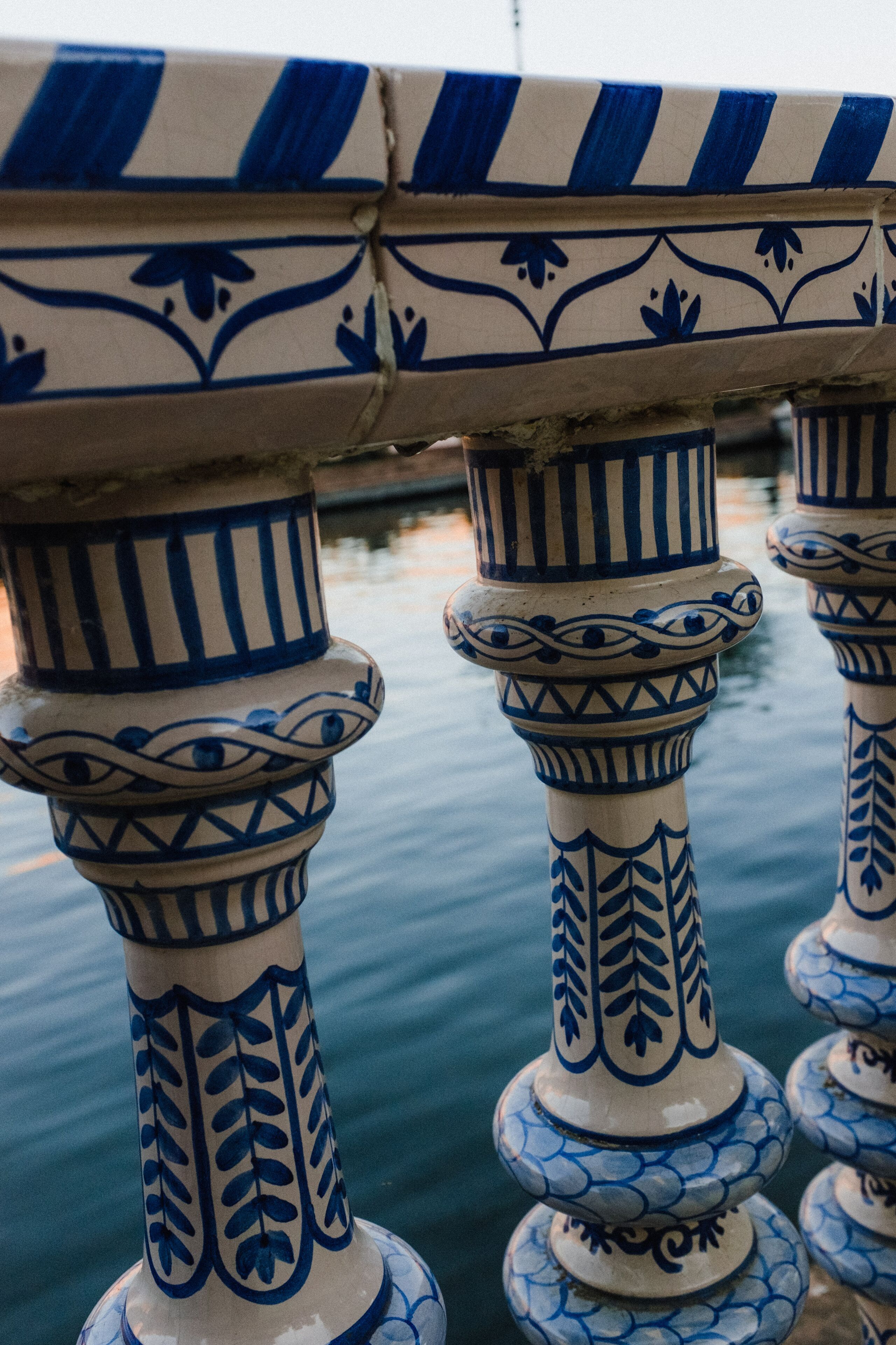 A series of blue and white patterned columns with intricate designs, likely part of a building's architecture.