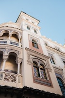 A building with ornate architectural details, including arches and intricate tile work.