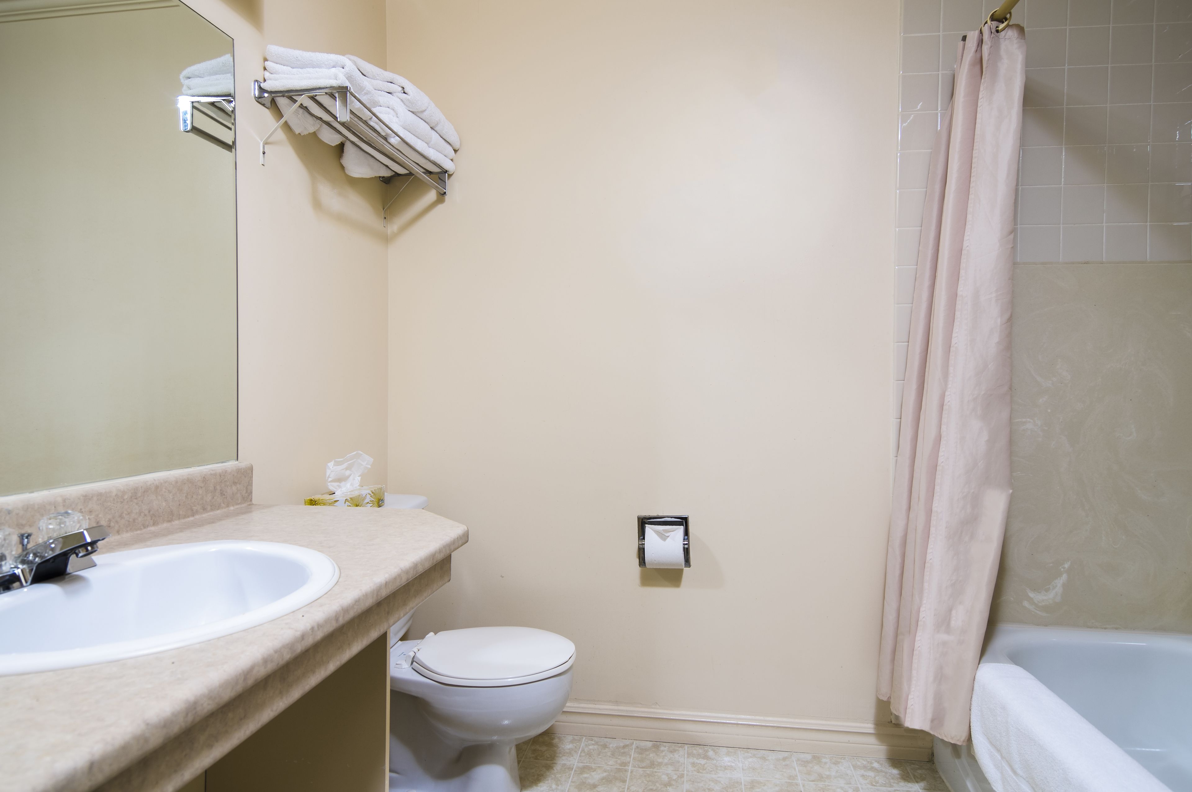 A bathroom with a sink, toilet, and bathtub.