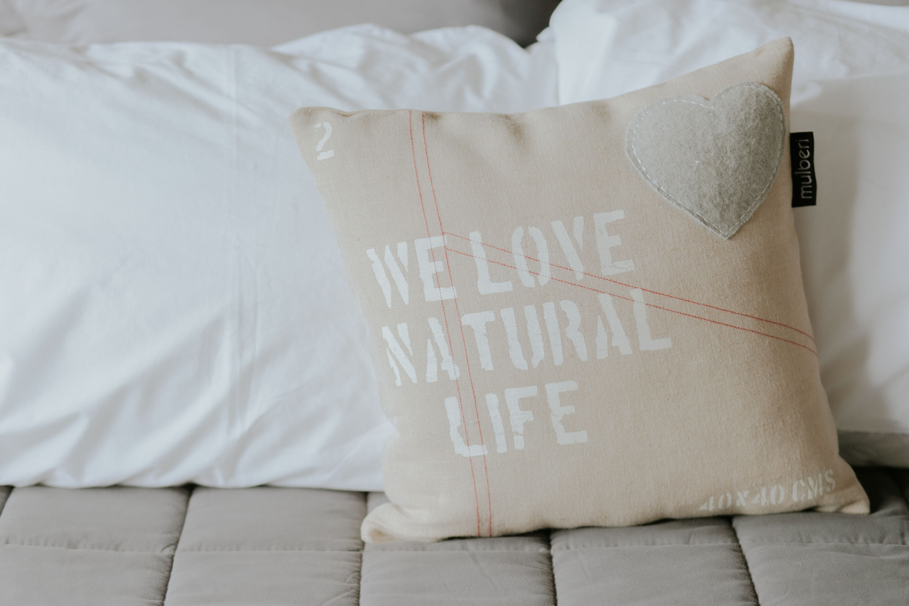 Almohada color beige con el texto 