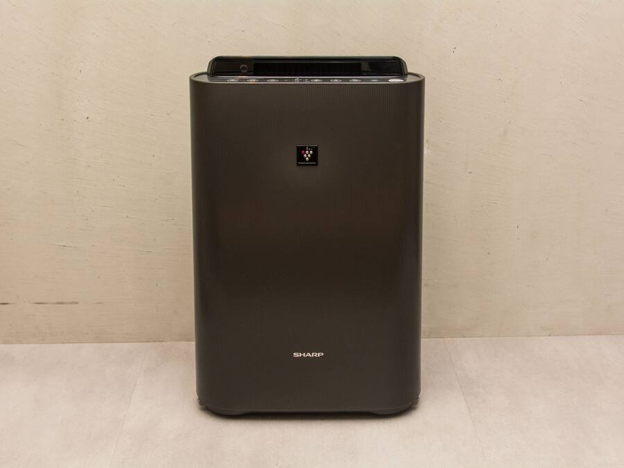 A black, rectangular, metallic object with a control panel and the brand name "SHARP" visible on the front.