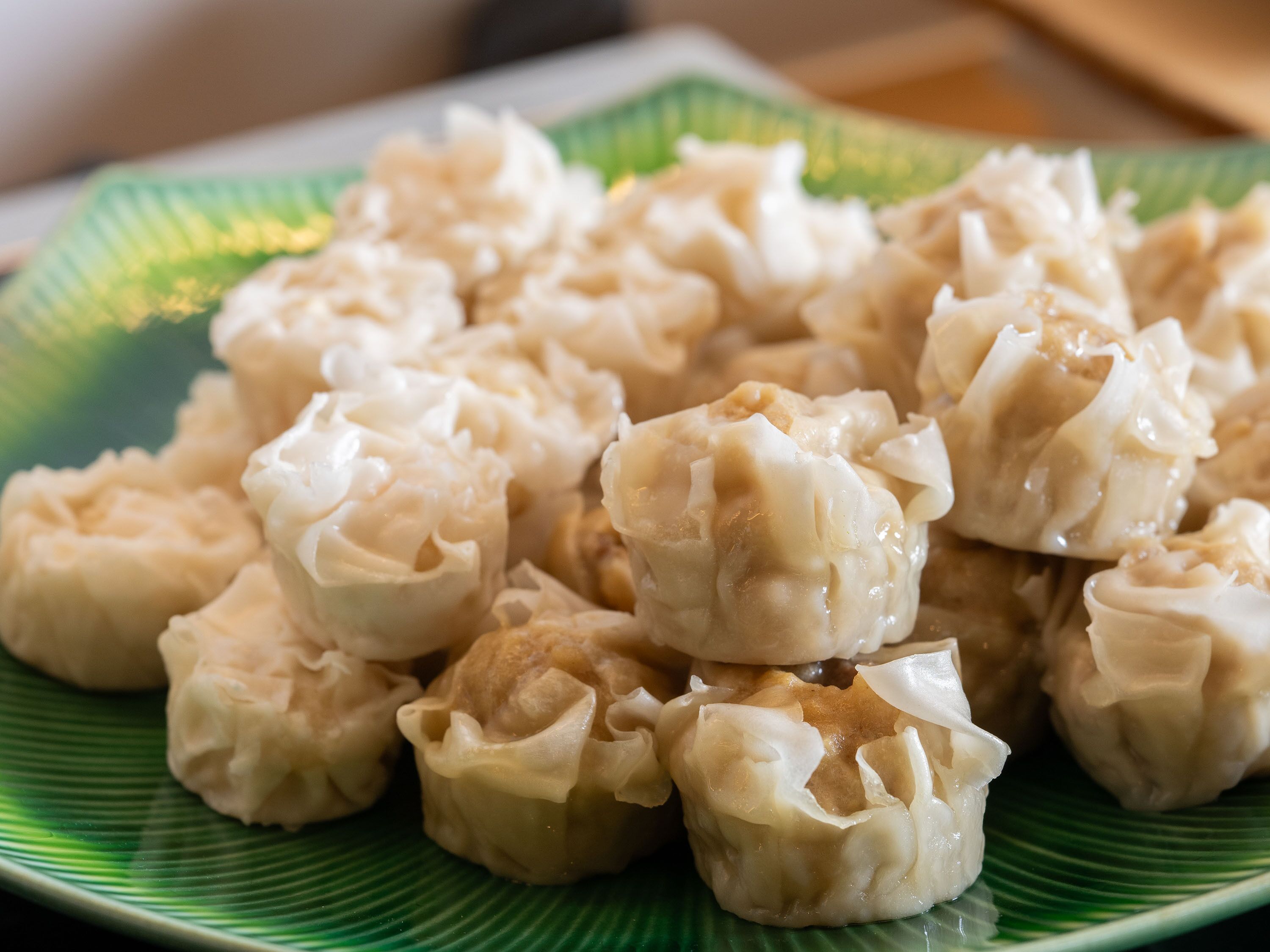 A plate of dumplings on a green plate.