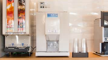 A vending machine with beverages, an ice dispenser, and a coffee machine.