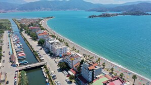 A coastal town with a marina, beachfront, and buildings with balconies overlooking the sea. - Calis Beach - Beautiful 4 bedroom villa with private pool and WiFi  (Fethiye)