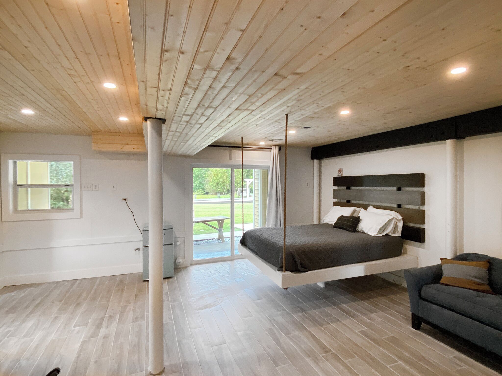 downstairs studio queen bed and sliding glass door to the exterios