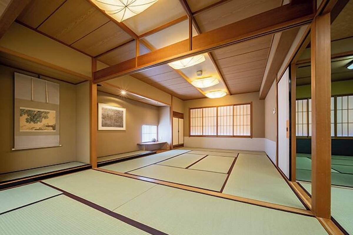 A traditional tatami mat room with sliding doors, a tatami mat floor, and a shoji screen.
