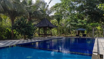 Una piscina al aire libre, cabañas de piscina gratuitas, sombrillas