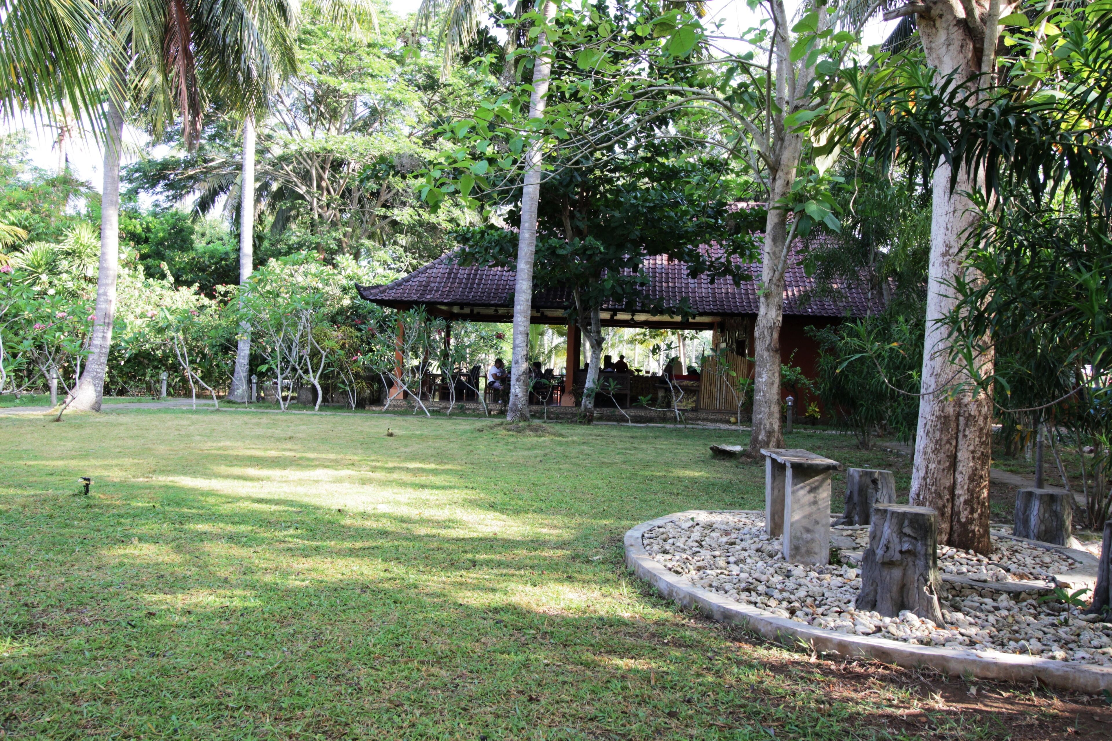 A park with a gazebo, trees, and a grassy area.