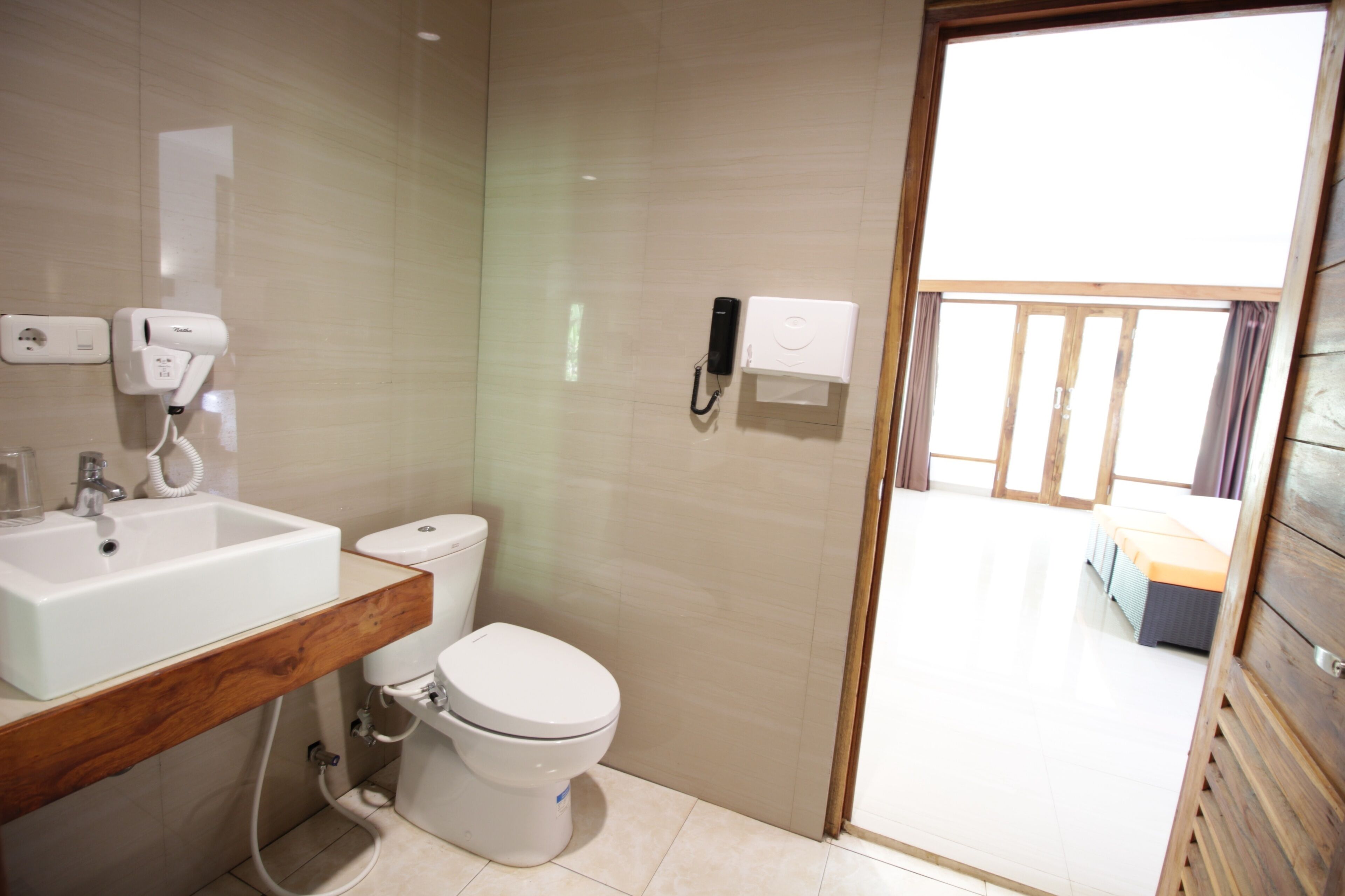 A modern bathroom with a sink, toilet, and shower area.