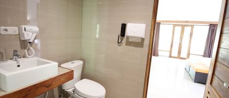 A modern bathroom with a sink, toilet, and shower area.