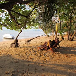 On the beach, white sand, sun-loungers, beach towels
