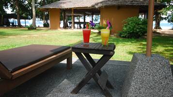 Relax on a serene outdoor space with a bench and table, surrounded by lush greenery and scenic views.