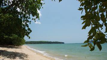 On the beach, white sand, sun loungers, beach towels