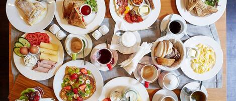 A breakfast buffet with various dishes including toast, eggs, bacon, and fruit.