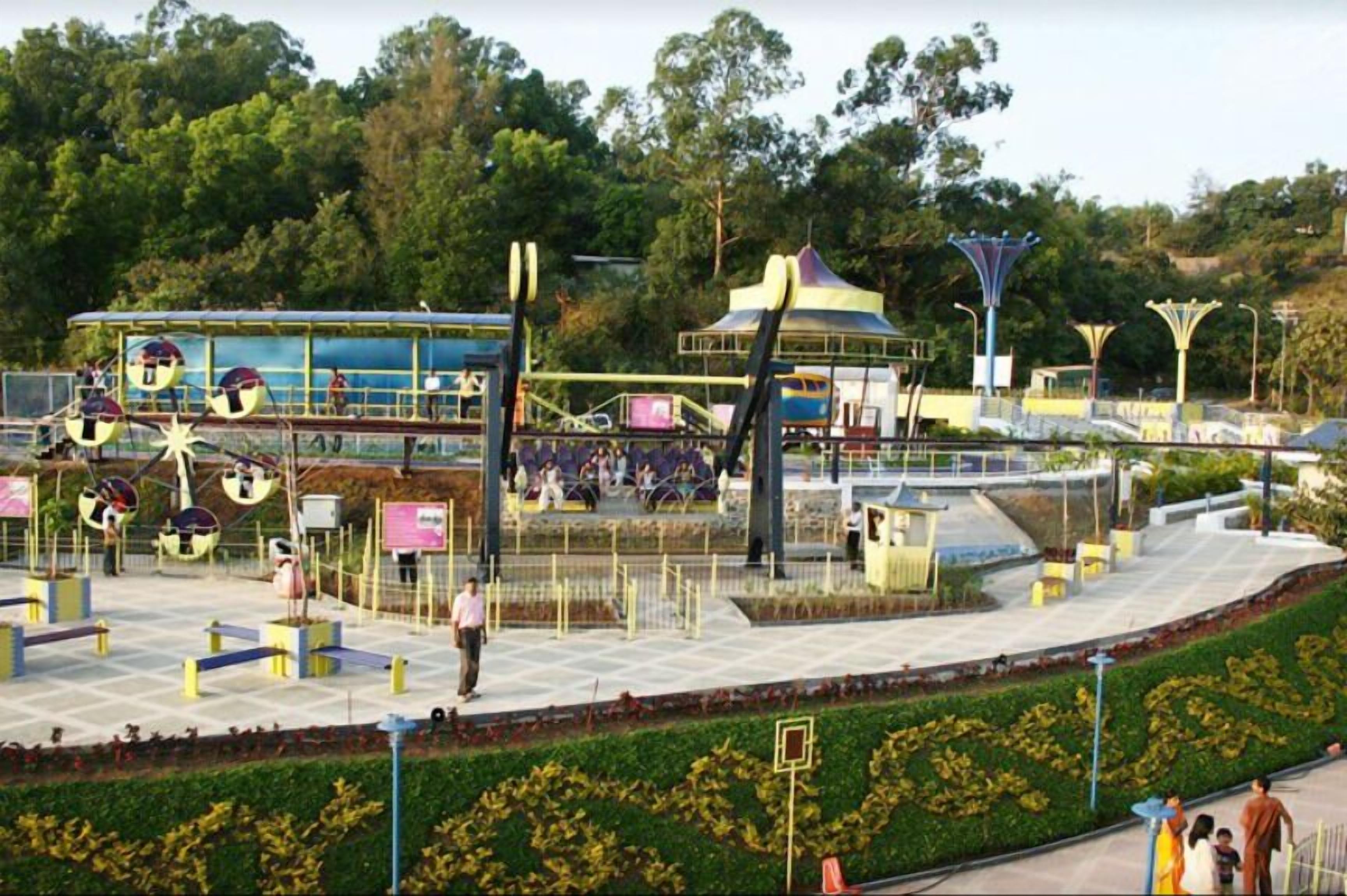 A park with playground equipment, a gazebo, and a fountain.