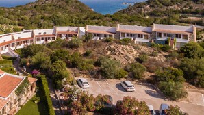 A coastal property with multiple villas, a parking area, and a view of the sea. - Capo Ceraso Family Residence (Olbia)