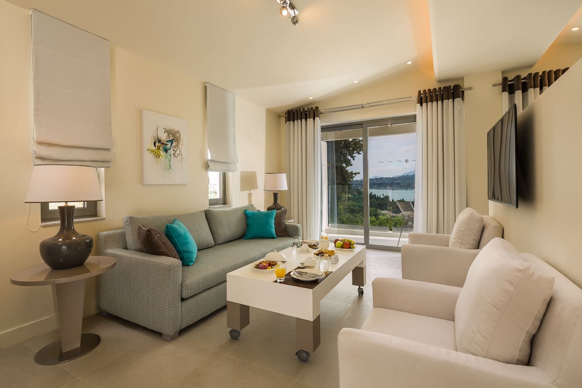 A modern living room with a sofa, a coffee table, and a TV.