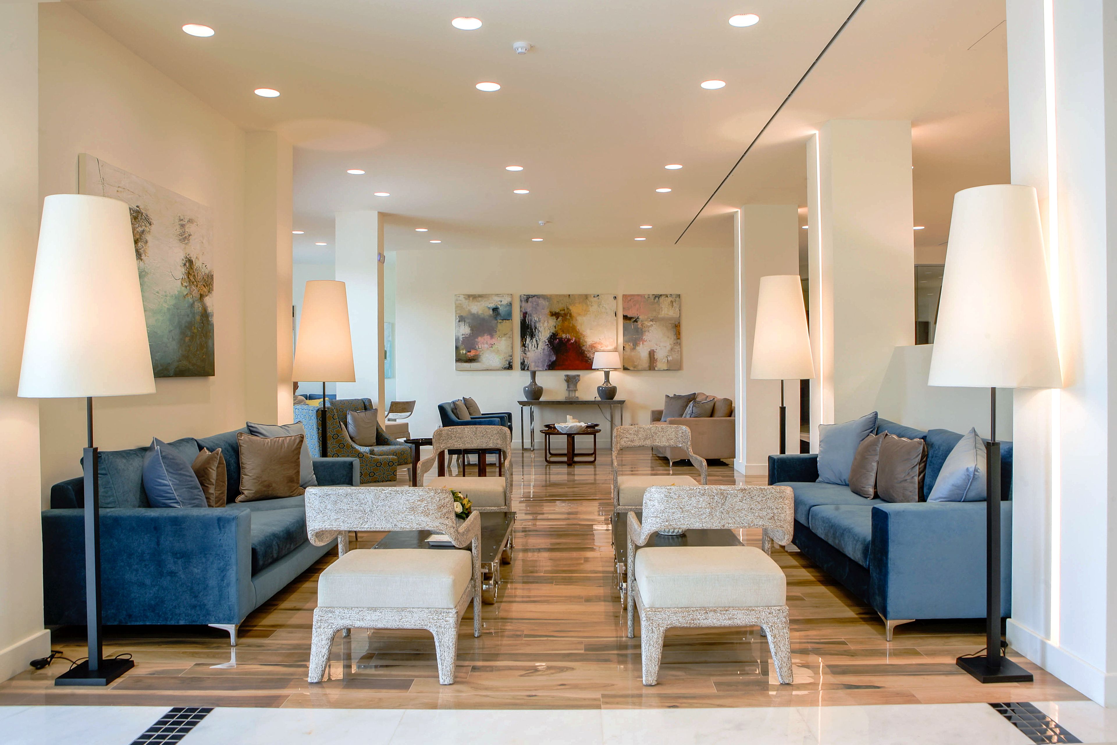 A spacious living area with two sofas, a coffee table, and a dining table.