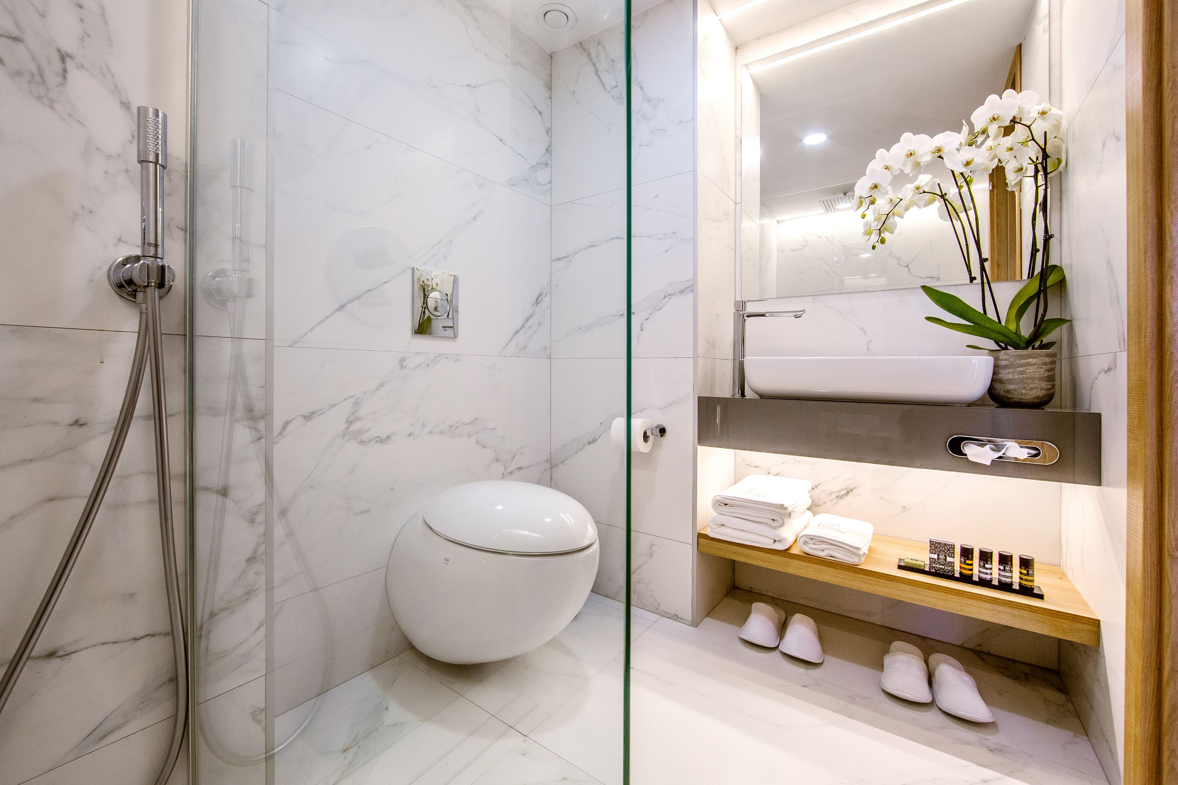 shower, hair dryer, slippers, towels