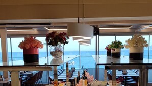 A buffet with various food items and a view of the sea. - Derici Hotel (Kusadasi)