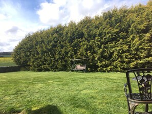A grassy outdoor area with a swing set and a covered seating area. - Balnabrechan Lodge (Arbroath)