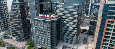 A high-rise building with a distinctive architectural design, featuring a central atrium and multiple floors.