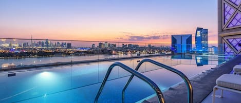 Una piscina al aire libre, camas de piscina gratis, sombrillas