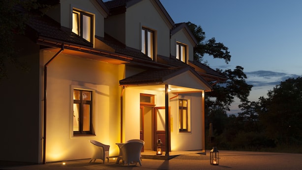 A two-story house with a porch, a chair, and a lantern. - Willa w Dolinie (Tarnow)