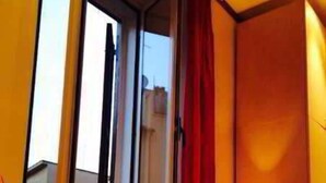 A room with a window, a radiator, and a lamp. - Gladiator's House (Rome)