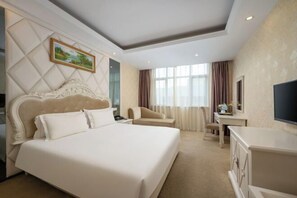 A hotel room with a large bed, a desk, a chair, a television, and a painting on the wall. - Yafeng Hotel (Huizhou West Lake) (Huizhou)