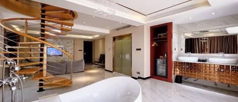 A modern bathroom with a freestanding bathtub, a wooden spiral staircase, and a vanity with multiple sinks.