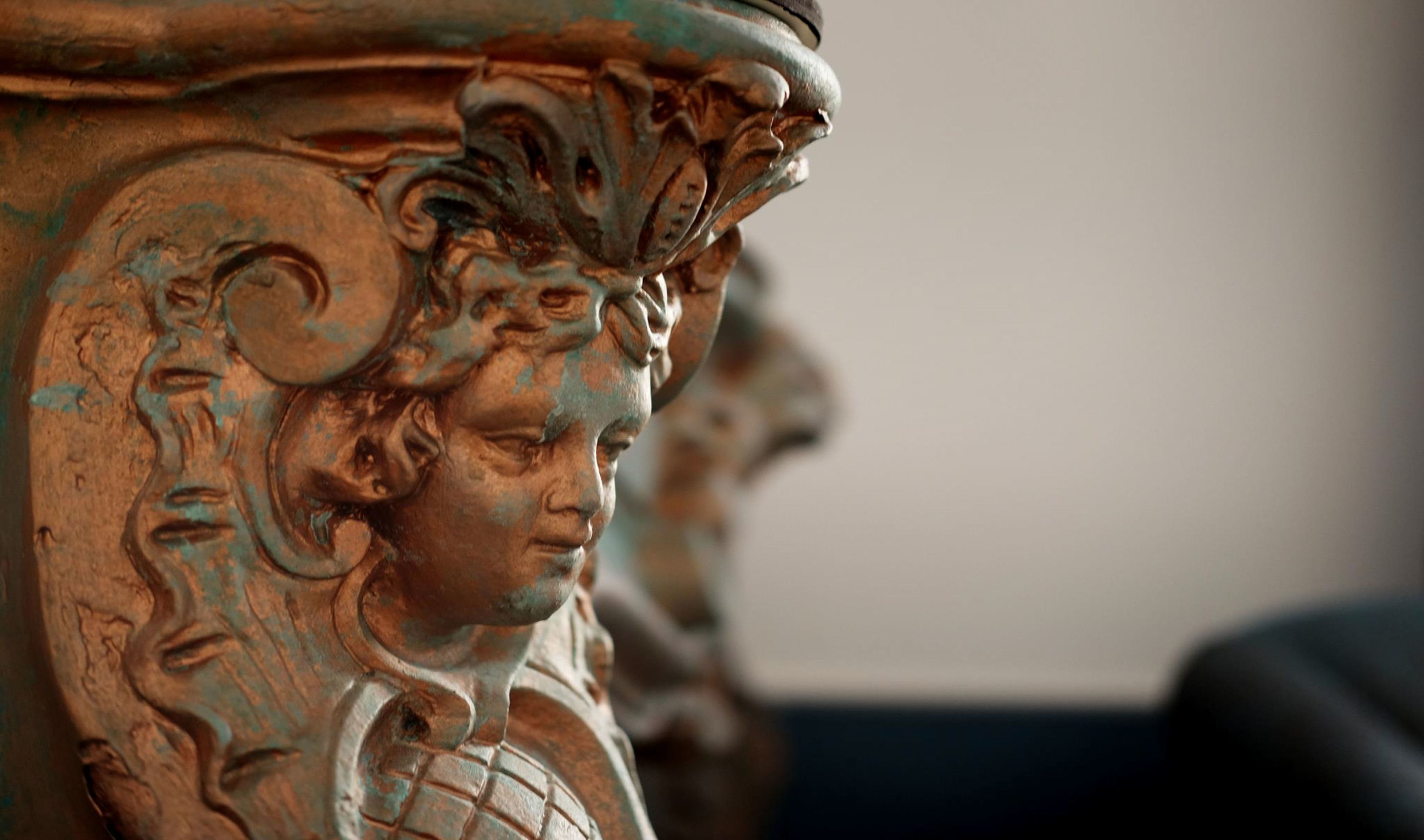 A close-up of a detailed architectural sculpture with intricate carvings and a weathered surface.