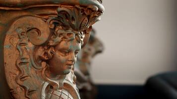 A close-up of a detailed architectural sculpture with intricate carvings and a weathered surface.