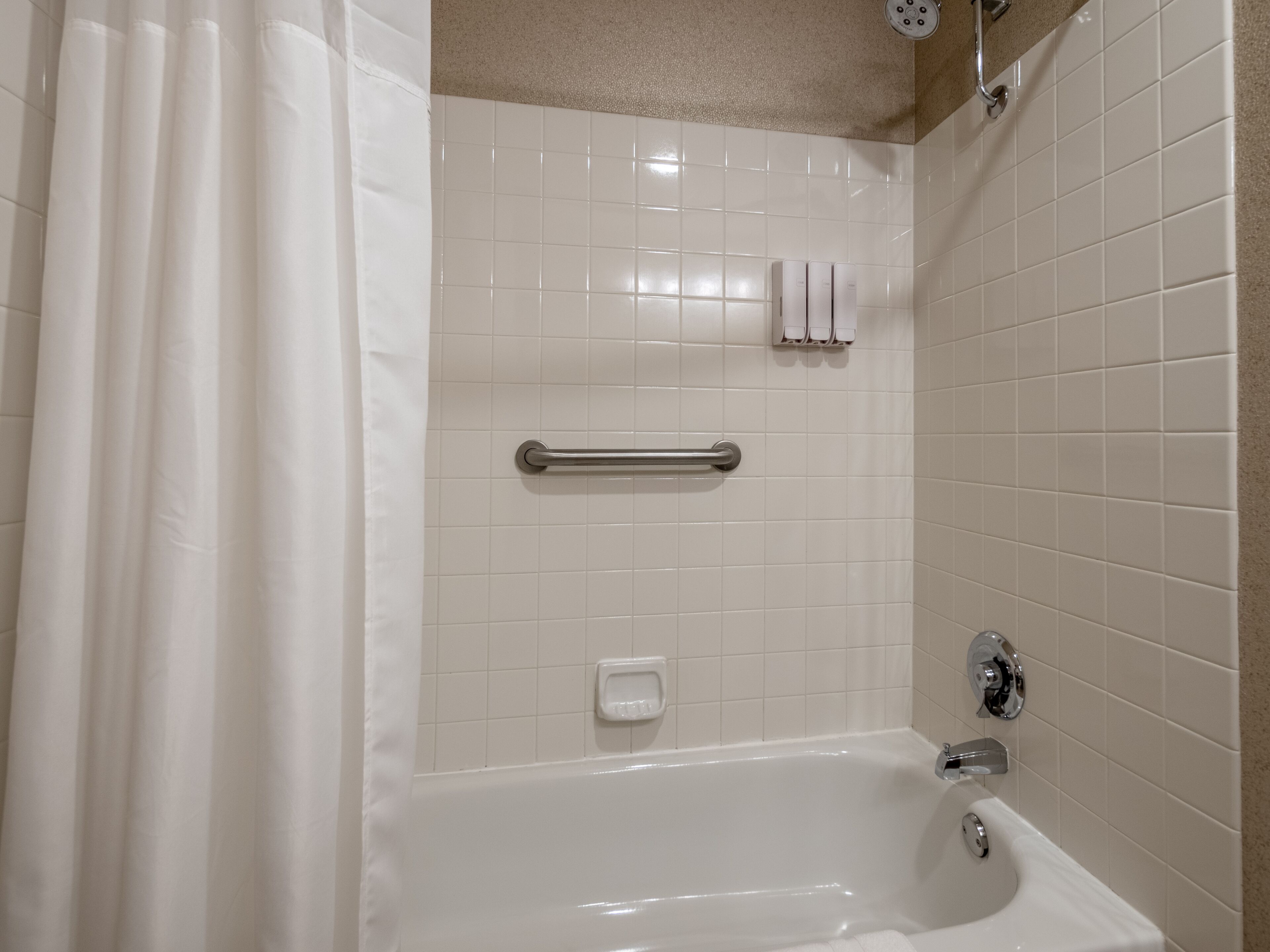 combined shower/bathtub, designer toiletries, hair dryer, towels