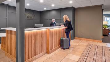 A hotel reception desk with a wooden finish and a modern design.